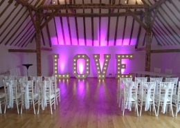 5ft LOVE with purple uplighters at skylarks gold club barn wedding