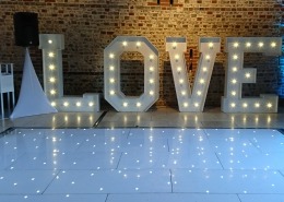 5ft LOVE uplighters and white led dancefloor at upwaltham barns