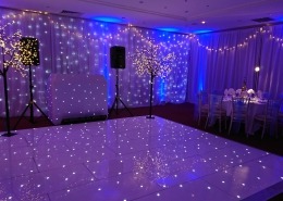 winter wonderland christmas parties at the portsmouth marriott white led dancefloor backdrop light up trees and full room drape